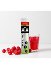 SIS Hydro Berry Electrolyte Sugar Free Hydration Tablets next to a glass of red drink and fresh raspberries
